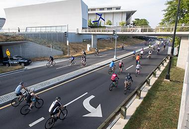 Bikers ride past the Kennedy Center in DC 