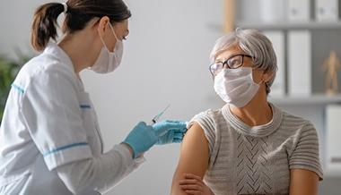 coronavirus vaccine myths covid-19 - doctor giving vaccine to mature patient