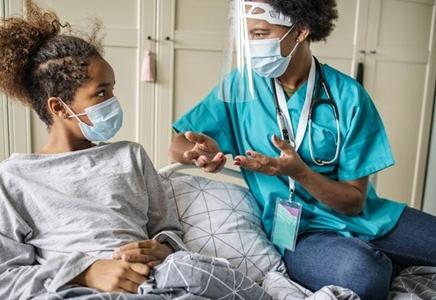 Nurse speaking with teen home care patient