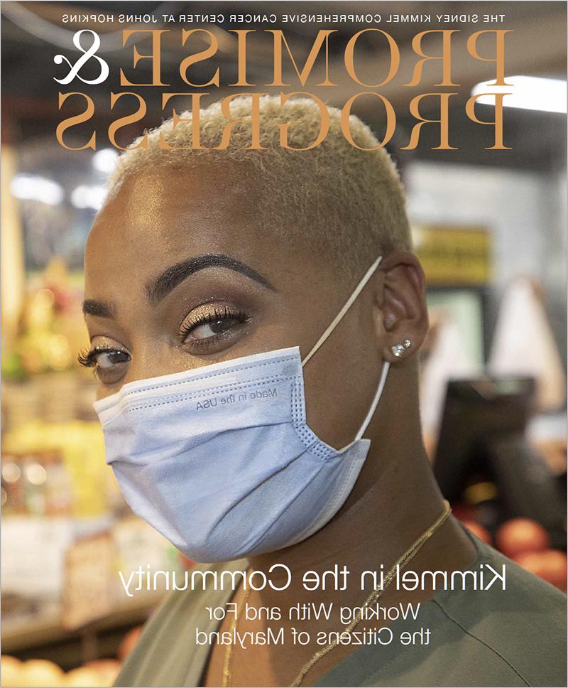 promise & 进步-kimmel在社区出版物封面上与戴面具的非裔美国妇女合影.